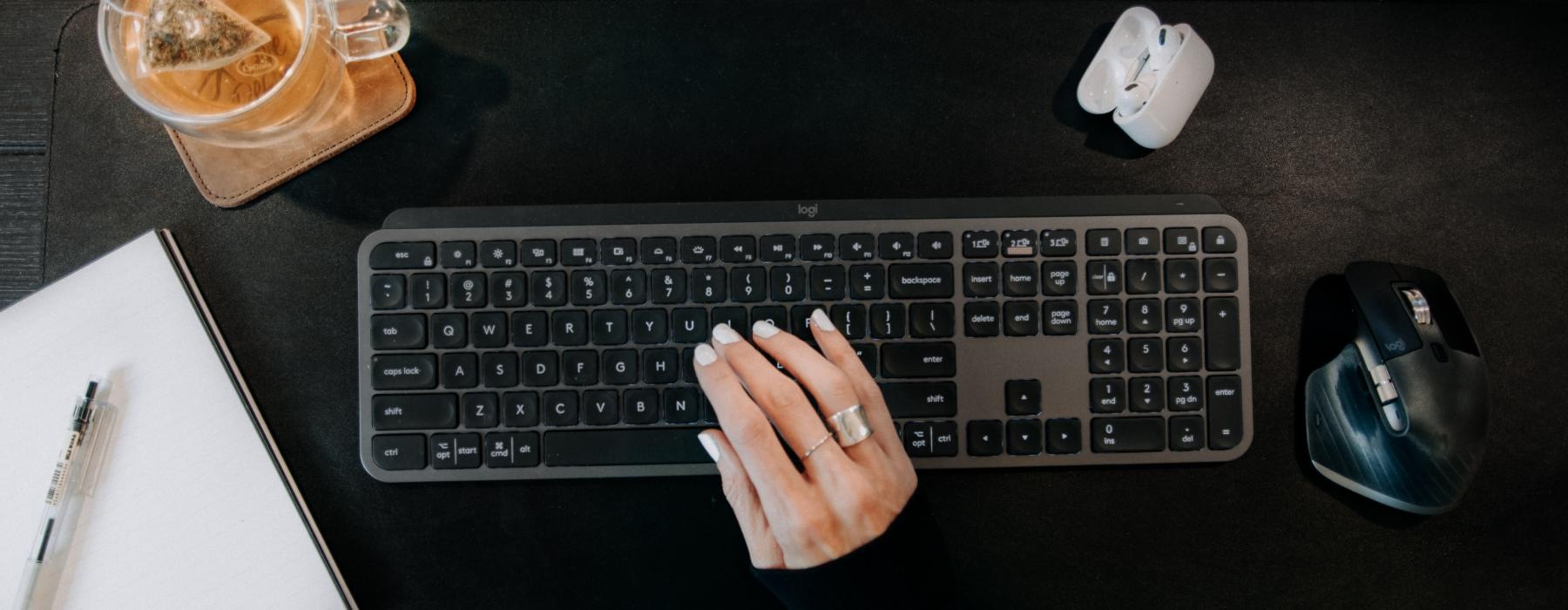 a person typing on a keyboard