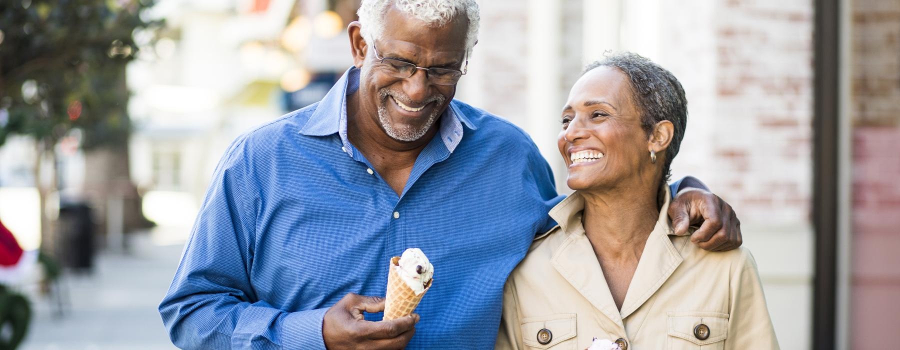 a man and woman holding ice cream cones